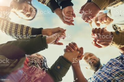 Shot of a group of friends putting their hands together